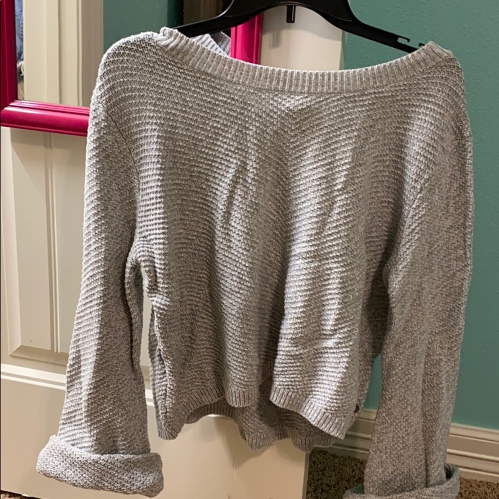 light blue sweater with wide opening on arms